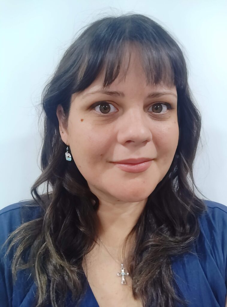 A headshot of Alexandra Belaskie wearing a blue shirt and smiling.